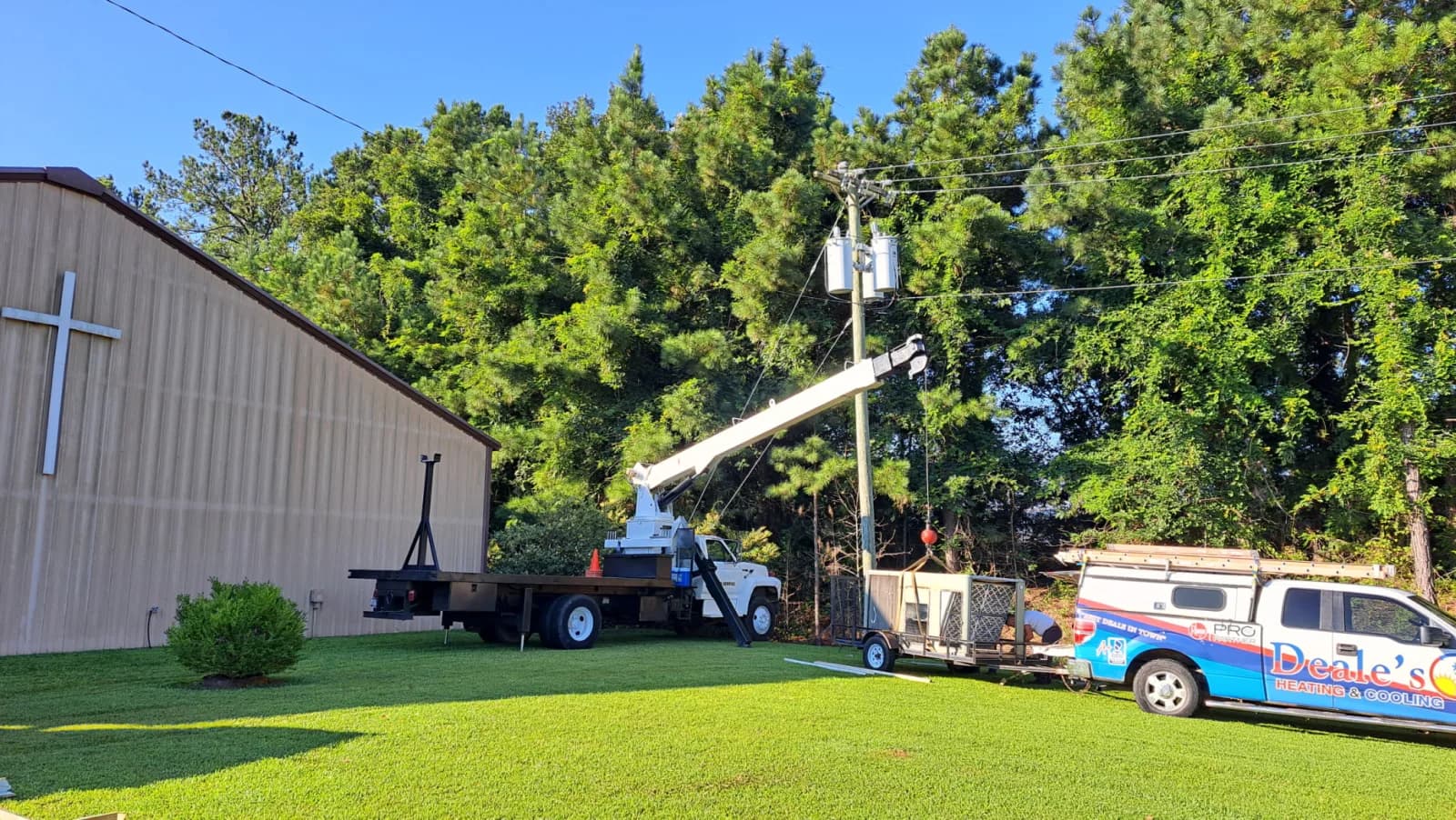 Boom truck setting an HVAC condenser unit at a commercial building